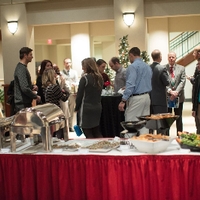 people gathering at the reception, a buffet table in the foreground